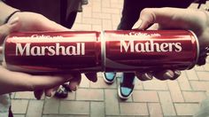 two people holding up red cans with the words marshall and others written on each one