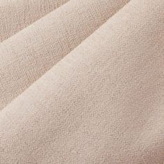 a close up view of a beige blanket