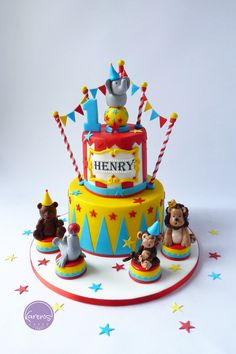 a birthday cake with bears and circus animals on the top is decorated in fondant