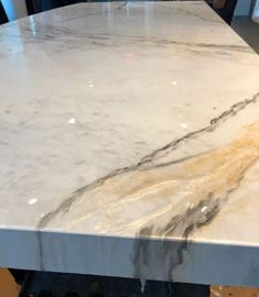 a marble counter top with yellow and black streaks on the edges, in a kitchen