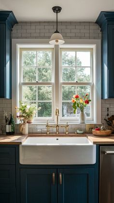 a kitchen sink sitting under a window next to a dishwasher