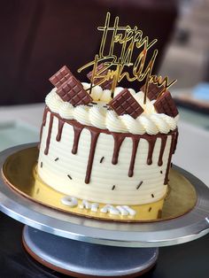 a birthday cake with white frosting and chocolate icing on top that says happy birthday