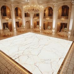 an empty ballroom with chandeliers and tables set up for a formal function in white marble