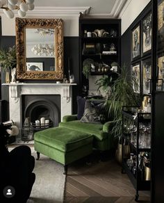 a living room filled with furniture and a fire place in front of a large mirror