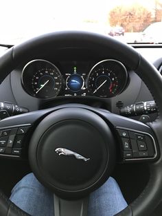 the interior of a car with gauges and steering wheel controls on it's dashboard