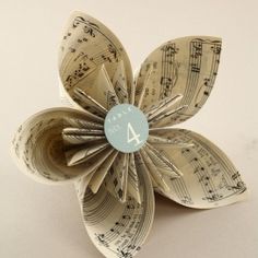 an origami flower with musical notes on it