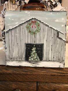 a painting of a barn with a christmas tree on it