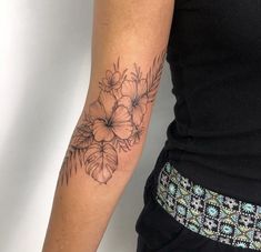 a woman with a flower tattoo on her arm