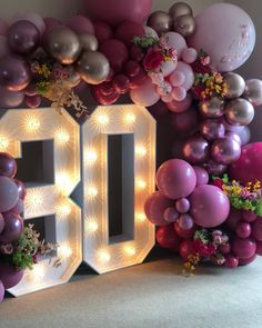 the number 50 is surrounded by balloons and flowers