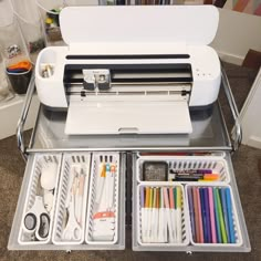 a sewing machine sitting on top of a table filled with lots of crafting supplies