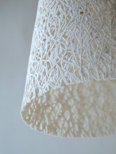 an intricately designed lamp shade hangs from the ceiling