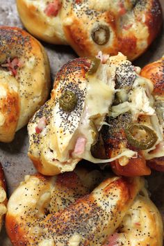 there are several bagels with different toppings on them and sprinkled in seasoning