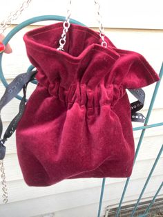 a red purse hanging from a metal rack