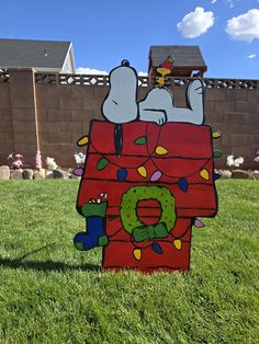 a snoopy christmas decoration in the yard