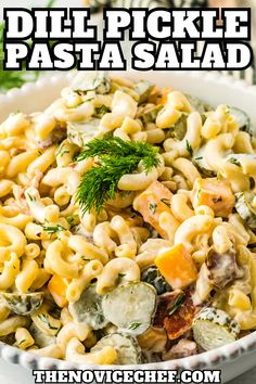 a bowl filled with pasta salad and topped with dill pickle