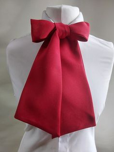 Pussey Bows are simply a ladies style bow tie. They make a real statement adding a splash of individuality to any outfit. They are very easy to tie just like a big shoe lace. As you tie the bow your self you can change the size and style of the bow to suit the look you are trying to achieve.  it is double sided so the pattern appears on both sides. It is hand wash only and has a total length of 160 cm.  I was invited to a wedding reception where all the men were requested to wear a bow tie, as i Elegant Red Satin Bow, Red Bow Standard Bow Tie For Party, Red Bow Tie For Party, Elegant Solid Color Bow, Pre-tied Decorative Bow Tie For Party, Pre-tied Bow Tie For Party, Pre-tied Bow Tie Back For Party, Elegant Red Bow Tie, Chic Satin Bow Tie For Formal Occasions