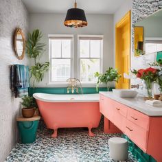 a bathroom with a pink bathtub and green plants in the window sill next to it