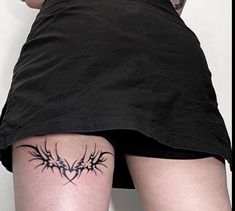 a woman with a tattoo on her thigh