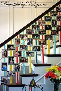 stairs decorated with pictures and ribbons for the staircases to go up in this house