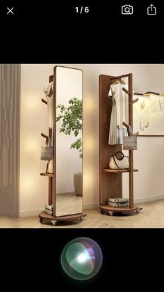 two mirrors and a shelf with clothes on it in a room next to a plant