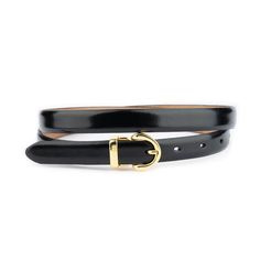 Introducing our Elegant Women's Black and Gold Belt, a chic and sophisticated accessory that perfectly marries Italian elegance with timeless design. This belt, crafted from genuine leather, offers both durability and a luxurious feel, making it an essential addition to any wardrobe. With a belt width of 3/4 inch (20 mm), it's ideally sized to complement a range of outfits, from cinching the waist of a flowing dress to adding a polished touch to a fitted blouse. The belt showcases a stunning gol Gold Belt Dress, Black And Gold Belt, Dress Italian, Fitted Blouse, Italian Dress, Italian Elegance, Flowing Dress, Gold Belt, Gold Belts