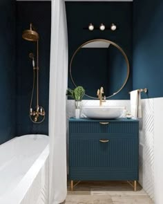 a bathroom with blue walls and gold fixtures on the vanity next to a bathtub