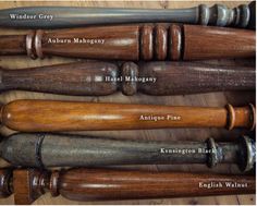 an assortment of old wooden baseball bats on a table with names and numbers in english