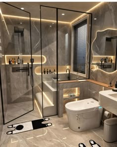 a modern bathroom with marble walls and flooring, lighted by recessed lighting above the toilet