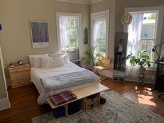 a woman is standing in the bedroom looking at her reflection on the mirror and bed