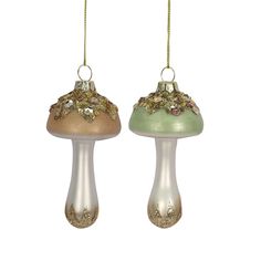 two glass ornaments hanging from chains on a white background, one with gold and green decorations