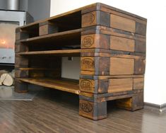 a large wooden shelf sitting on top of a hard wood floor next to a fire place