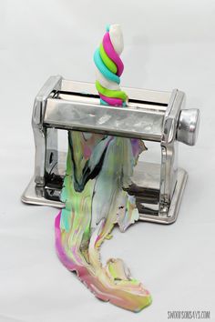 a multicolored object sitting on top of a toaster with something coming out of it