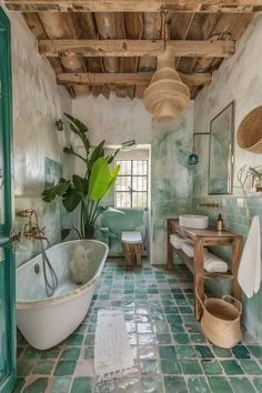 the bathroom is decorated in green and white tile with an old bathtub next to it