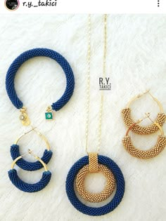 three different necklaces on a white surface, one is blue and the other is gold