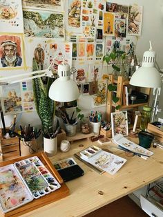 a desk with many pictures and plants on it