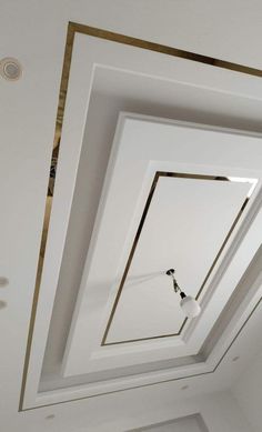 an empty room with white walls and gold trimmings on the ceiling is shown