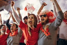 group of people in red and grey shirts cheering