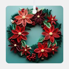 an ornament with poinsettis and berries hanging on a blue background