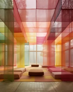 a room with many different colored squares on the walls and floor, along with benches