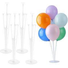 there are many balloons and sticks in the vases on the table, one is white