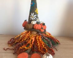 a decorative hat made out of yarn and pumpkins