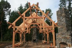 a house being built in the woods with lots of wood on it's sides