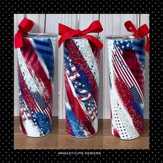 three patriotic tumbles with red, white and blue designs on them are wrapped in ribbon