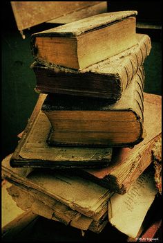 a stack of old books sitting on top of each other