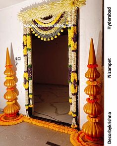 a decorated mirror in the middle of a room with flowers and decorations around it on either side