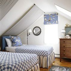 two beds in a bedroom with blue and white checkered sheets on the bedspread