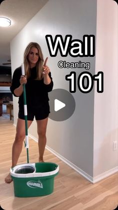 a woman is cleaning the floor with a mop