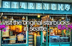 the outside of a store with purple flowers in front of it and an advertisement that says, visit the original starbuckss in seattle