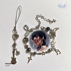 a necklace with an image of a woman holding a guitar and other charms on it