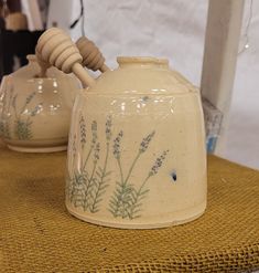 two ceramic teapots sitting on top of a table